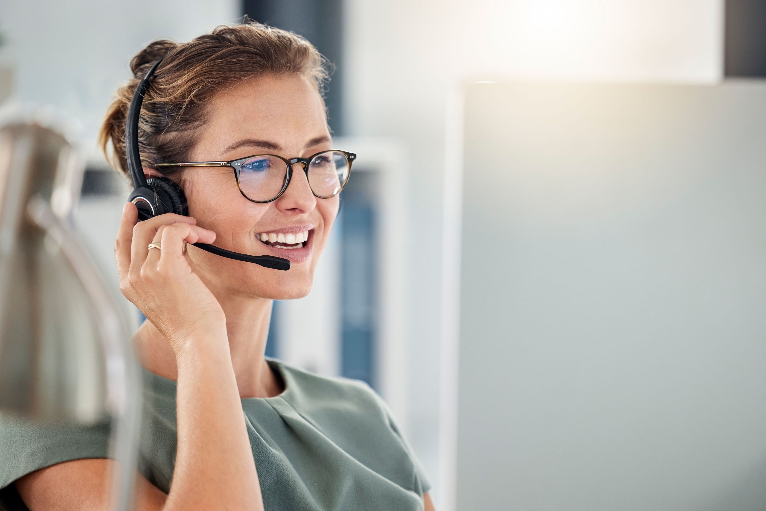 Happy call center woman consulting customer for customer support, help or telemarketing sales. Sales advisor, CRM girl with smile for success customer service, contact us hotline or insurance deal.